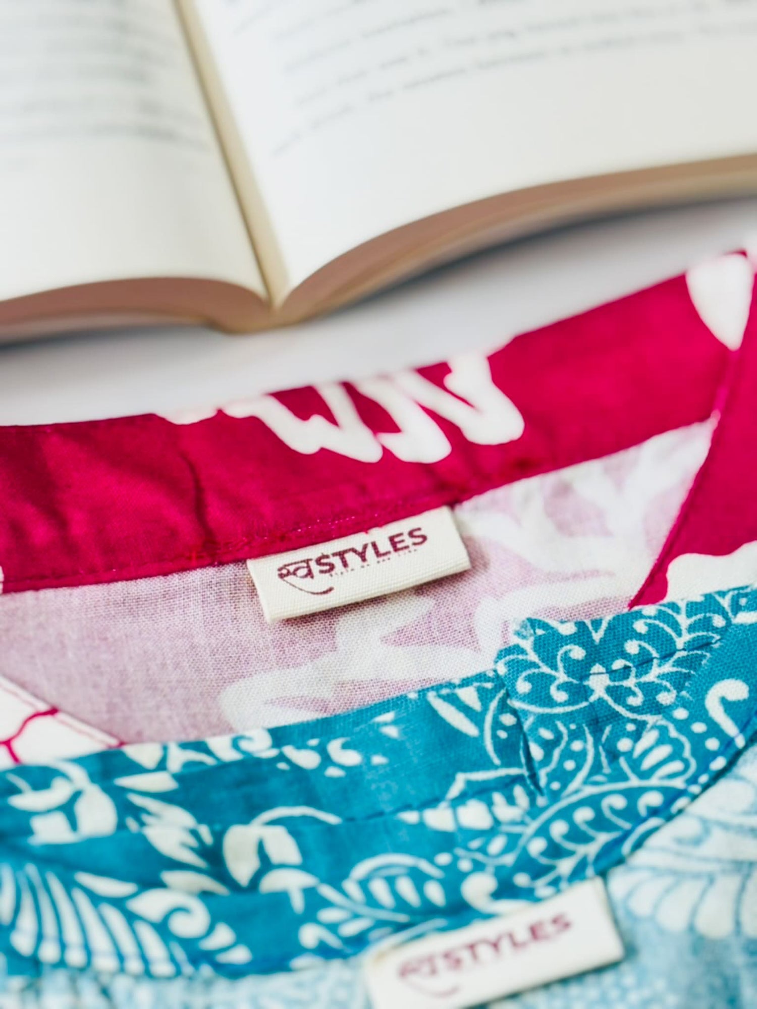 Textiles with 'swastyles' labels on a white background